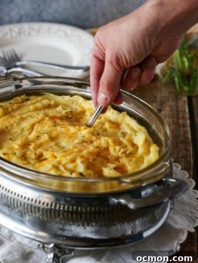 Creamy and fluffy mashed potatoes are taken to the next level of delicious with the addition of sharp cheddar cheese for a side dish everyone will love. Recipe on www.accidentalhappybaker.com @AHBamy