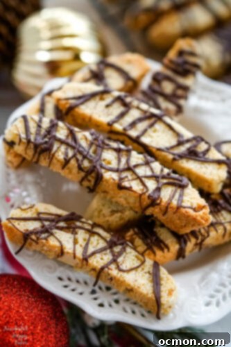 Artisan Chocolate Almond Biscotti 4 A white serving plate with a pile of Chocolate Almond Biscotti stacked on top.