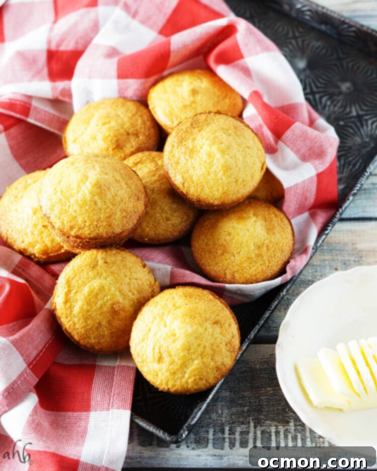 Boxed Cornbread: The Secret to Baking Brilliance 3 A tray of baked corn muffins next to a stick of butter.