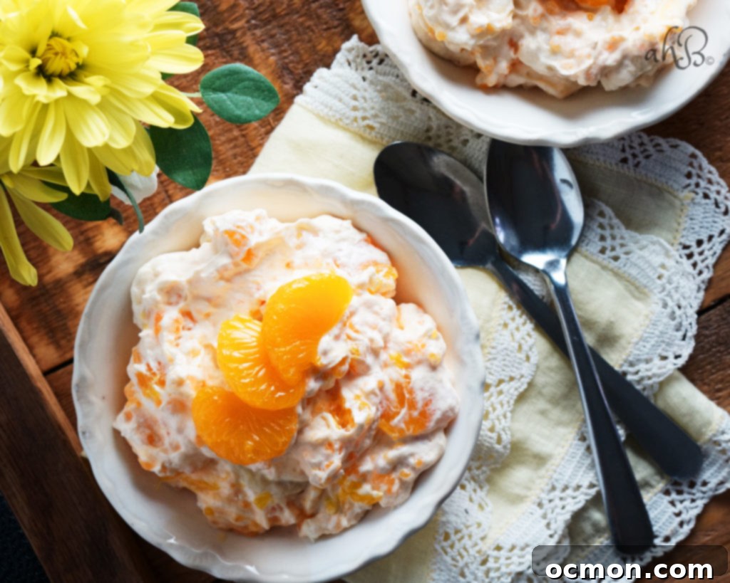 Vibrant Orange Dream Salad in a glass bowl, showcasing creamy texture and mandarin orange slices.