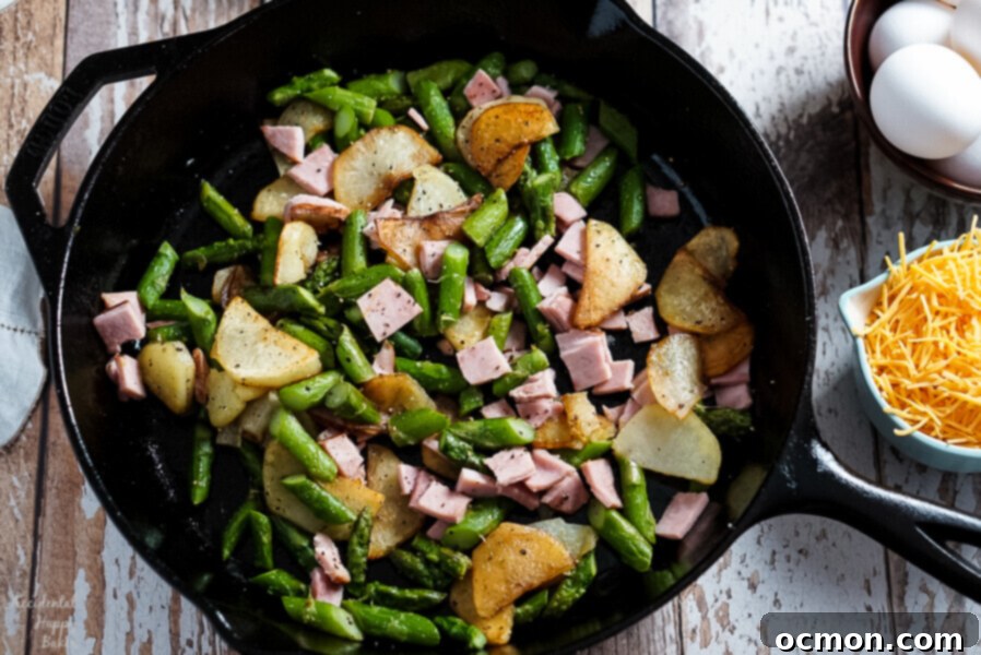 Hearty Ham, Asparagus, and Potato Frittata 3 Potatoes, Ham, and Asparagus are cooked in a cast iron skillet before adding the eggs.