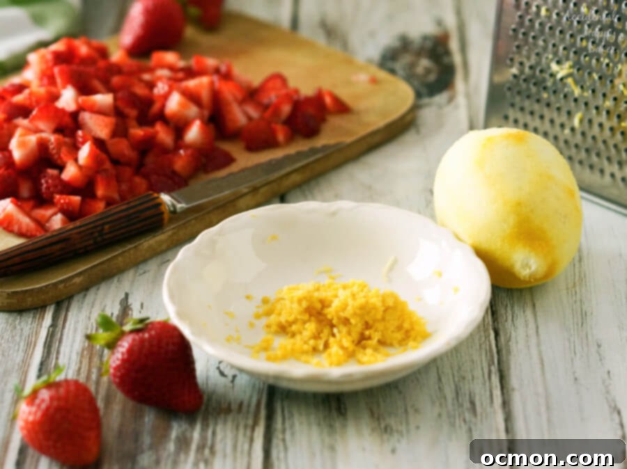 A bowl of lemon zest and chopped strawberries.