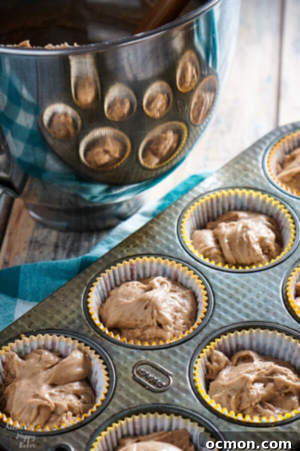 Warmly Spiced Nutella Indulgence 3 Unbaked Spiced Nutella Cupcakes in a muffin tin, ready to go into the oven