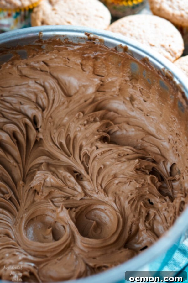 Warmly Spiced Nutella Indulgence 4 Close-up of a Spiced Nutella Cupcake topped with chocolate whipped Nutella frosting, showcasing its moist texture
