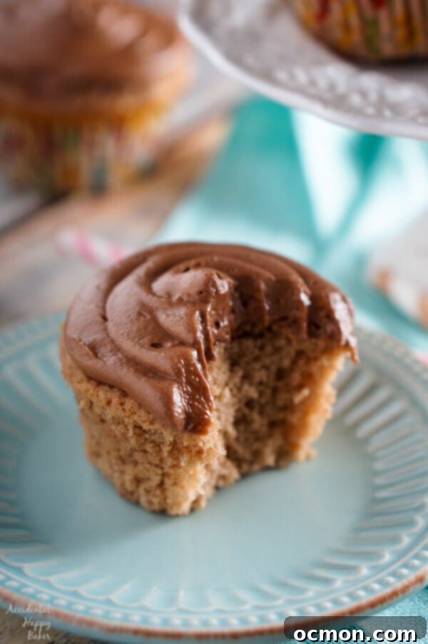 Warmly Spiced Nutella Indulgence 7 Two Spiced Nutella Cupcakes with simple, rustic chocolate whipped Nutella frosting on a cooling rack