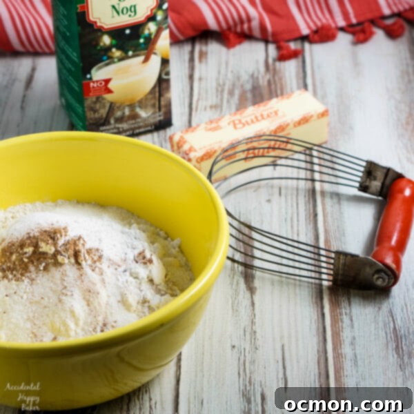 Three Eggnog Scones arranged on a festive holiday plate with Christmas tree decorations in the background