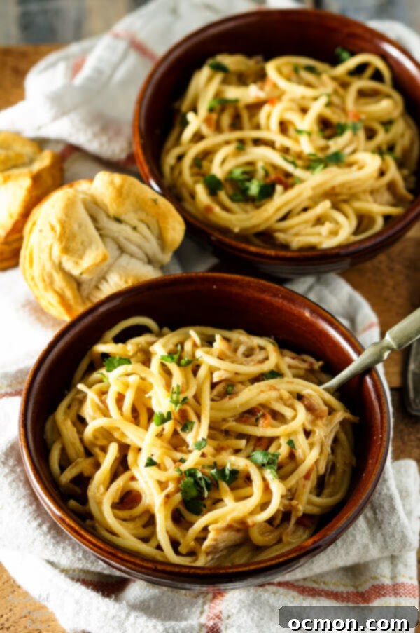 Bowl of hot, cheesy crockpot chicken spaghetti ready to be served