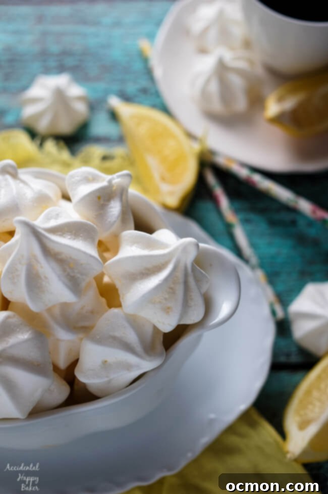A close-up shot of a bowl filled with various lemon meringue kiss cookies, highlighting their delicate form and golden hue.
