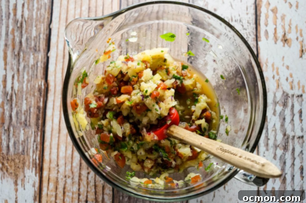 Easy Pineapple Salsa in a bowl with a serving spoon