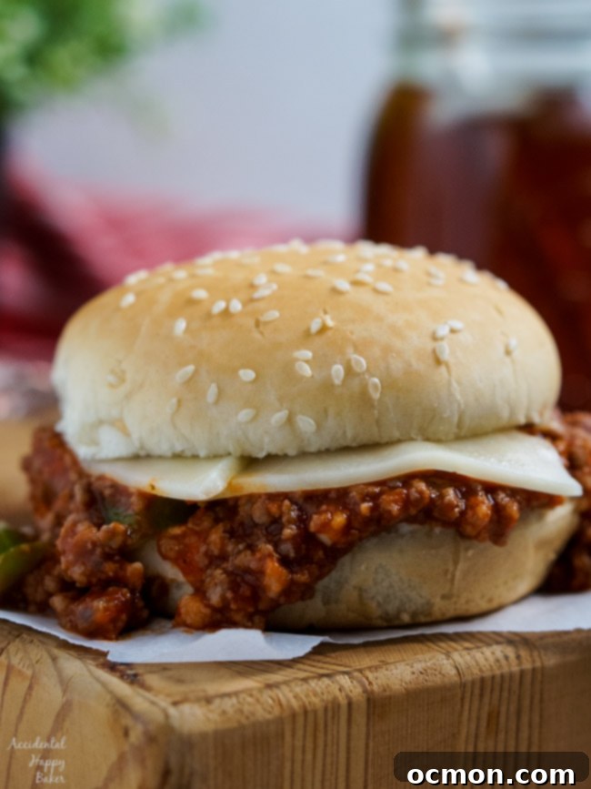 An Italian Sloppy Joe Sandwich sitting on a cutting board, garnished with fresh parsley.