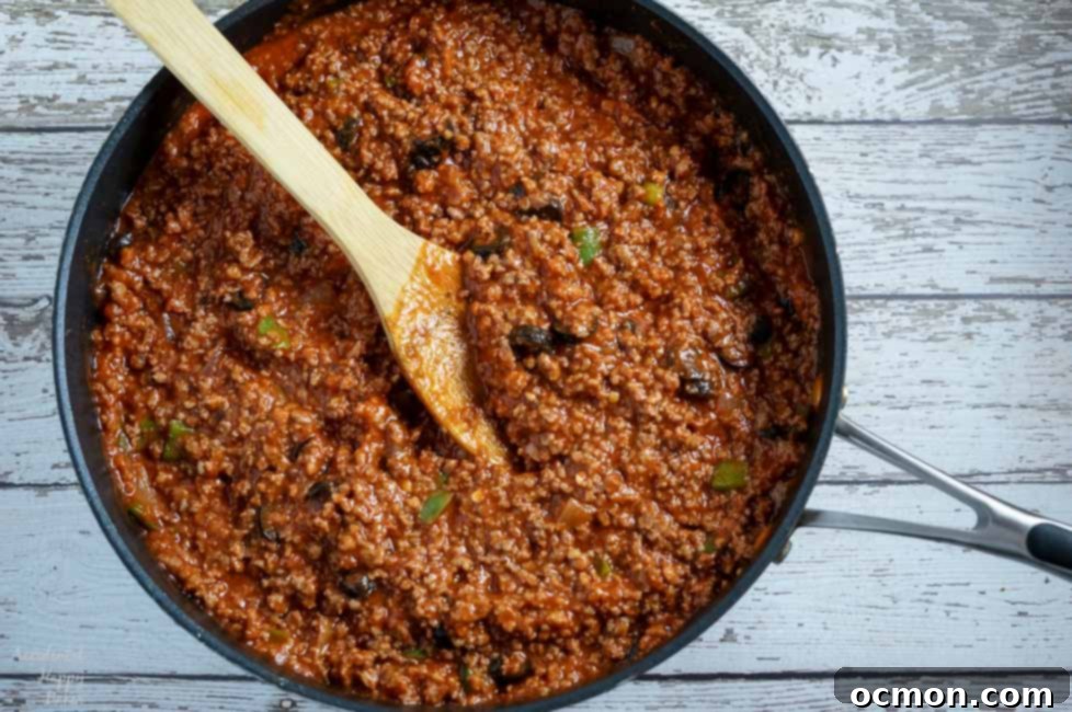 A pan of Italian Sloppy Joe filling, rich with meat and sauce, ready to be spooned onto toasted buns.