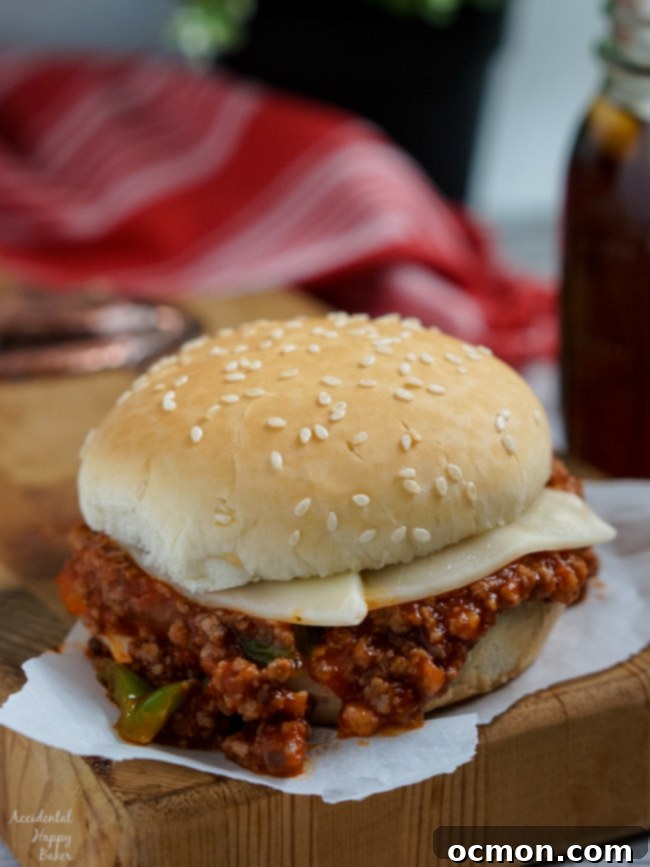 A beautifully assembled Italian Sloppy Joe sandwich, showing the melted provolone cheese and rich filling.