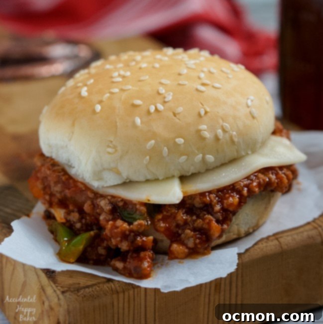 A square image of an Italian Sloppy Joe sandwich on a cutting board, ready to eat.