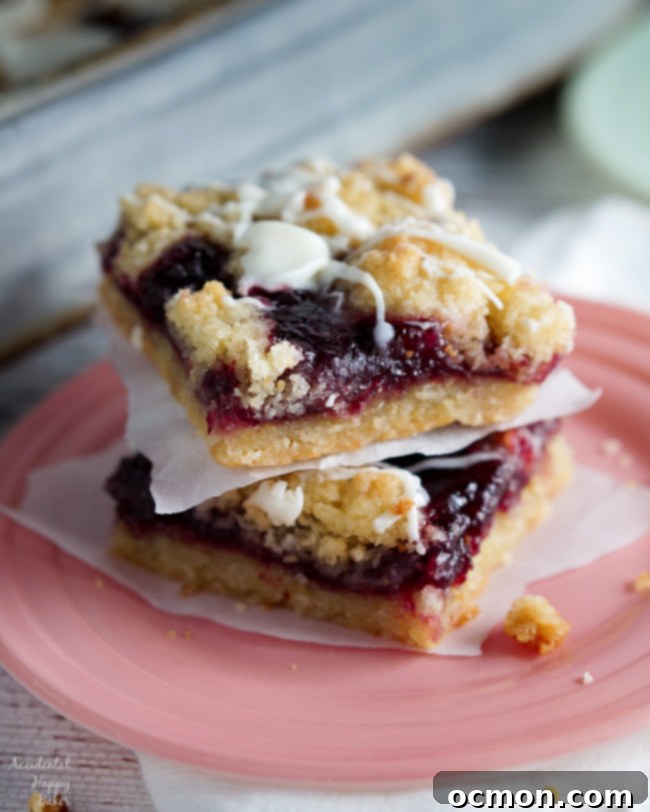 Raspberry White Chocolate Shortbread Bars 7 Two Raspberry White Chocolate Shortbread bars sitting on a plate