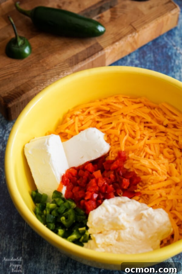 Jalapeno Pimento Zest 5 Sharp cheddar, cream cheese, may, pimentos and jalapenos in a bowl.