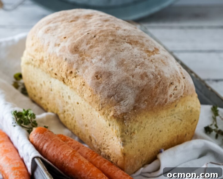 Garden Carrot & Chive Loaf 2 A beautifully baked loaf of homemade carrot and chive bread, showing its rustic crust and texture.