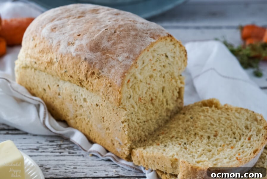 Garden Carrot & Chive Loaf 7 A freshly baked and sliced loaf of carrot and chive bread, ready to be enjoyed, showcasing its warm, inviting interior.