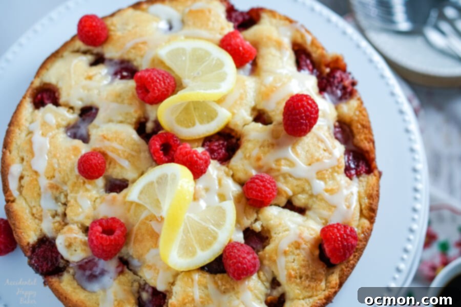 Raspberry Coffee Cake sitting on a cake plate. 