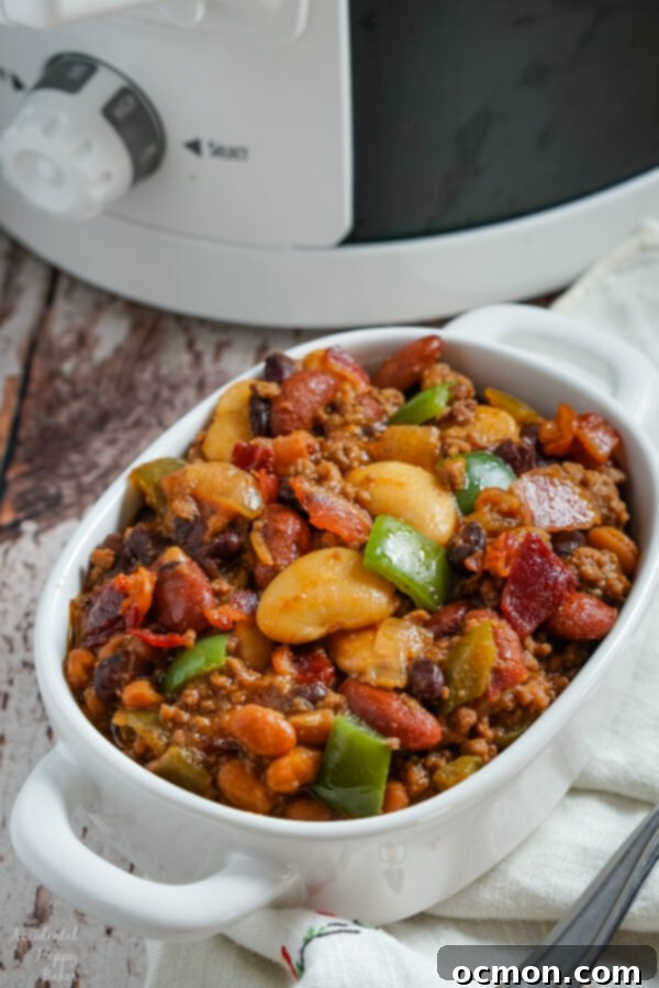 Various colorful canned beans, including butter beans, kidney beans, and black beans, along with a can of pork and beans, ready to be added to the slow cooker.