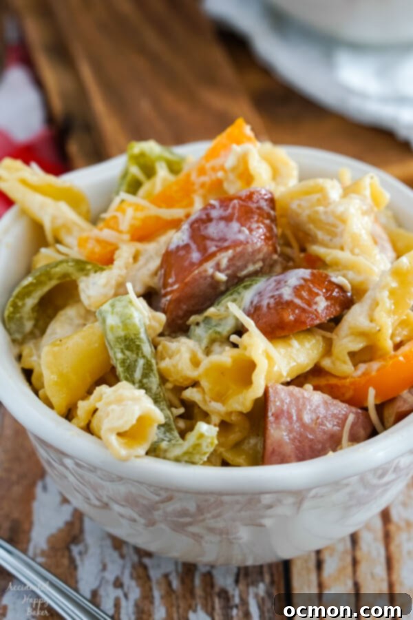 Cajun Kick Alfredo 2 A vibrant skillet of Cajun Sausage Alfredo pasta, rich with creamy sauce, sliced smoked sausage, and colorful bell peppers. A perfect quick weeknight dinner.