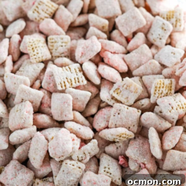 A closeup photo showing the pink cheesecake coating on the rice chex cereal. 