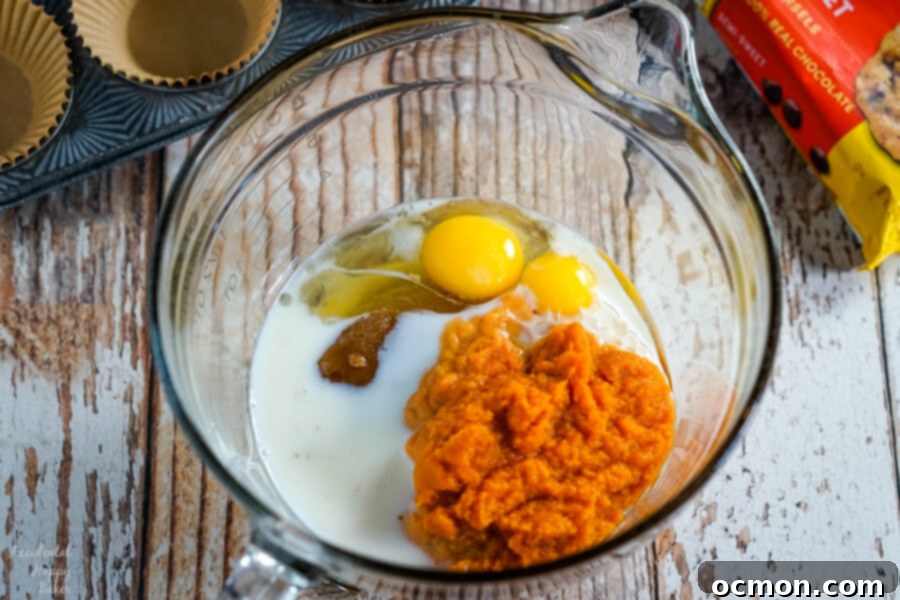 Spiced Pumpkin Chocolate Chip Muffins 4 Freshly baked pumpkin chocolate chip muffins cooling on a wire rack.