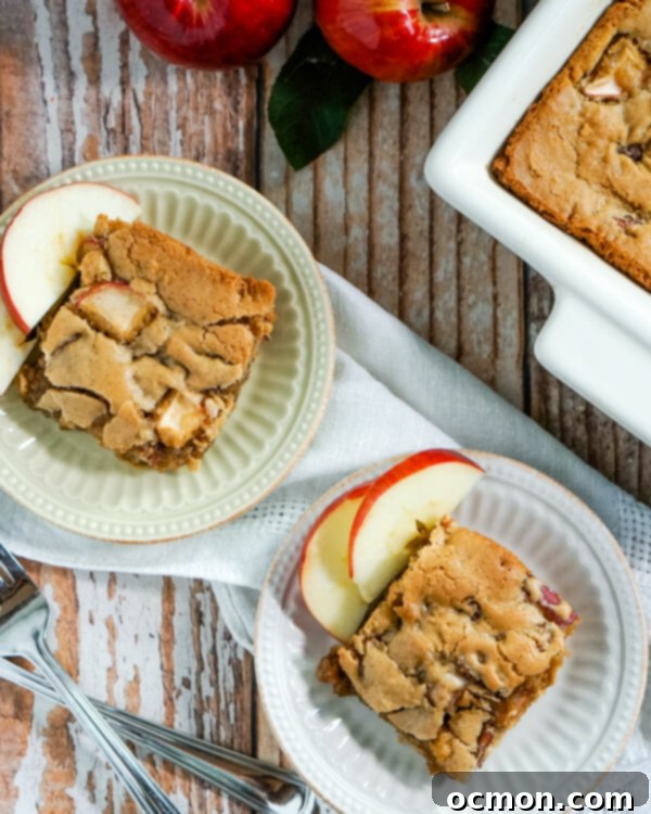 Freshly baked apple cinnamon bars, with a few pieces on plates next to the pan.