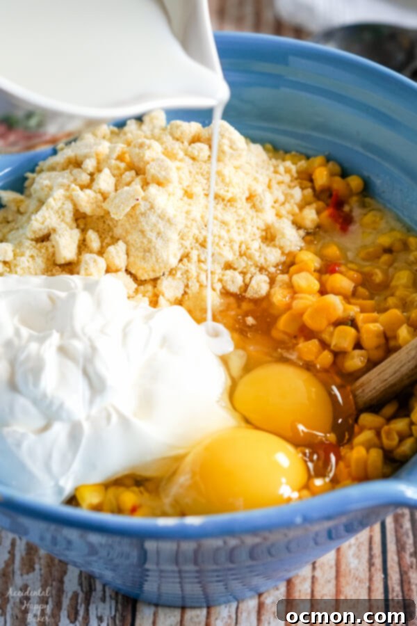 Creamy Slow Cooker Corn Bake 5 A slow cooker filled with Crock Pot Corn Casserole before cooking, showing the mixture.