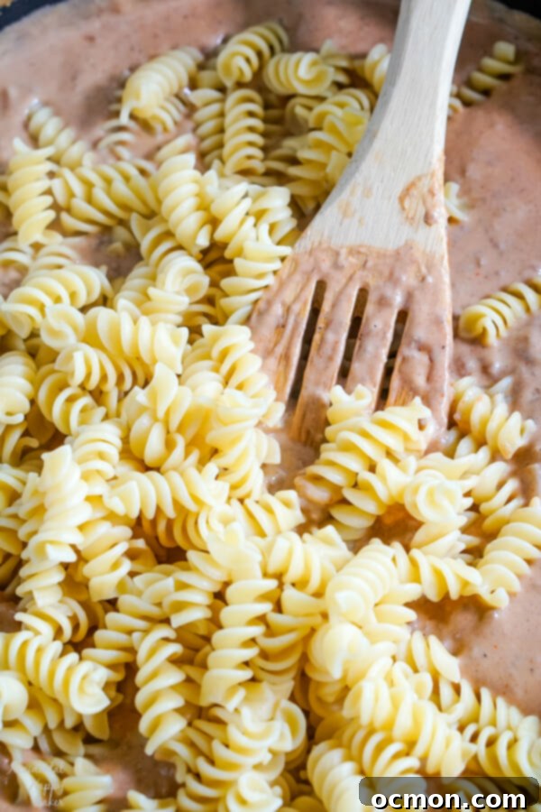 After the sauce is made, the cooked noodles are added.