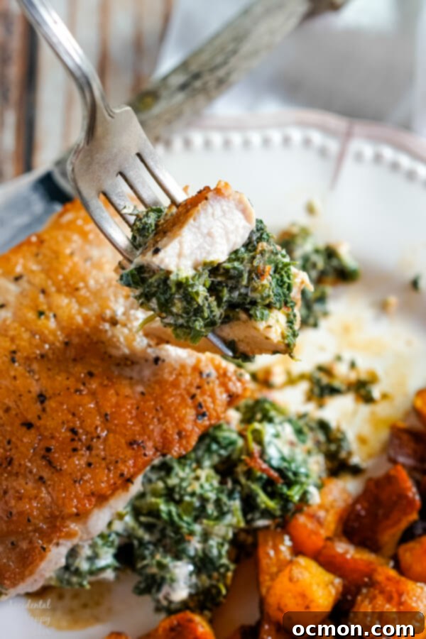 Savory Spinach-Filled Pork Chops 3 Close-up of a perfectly cooked spinach and cheese stuffed pork chop, showing the generous creamy filling