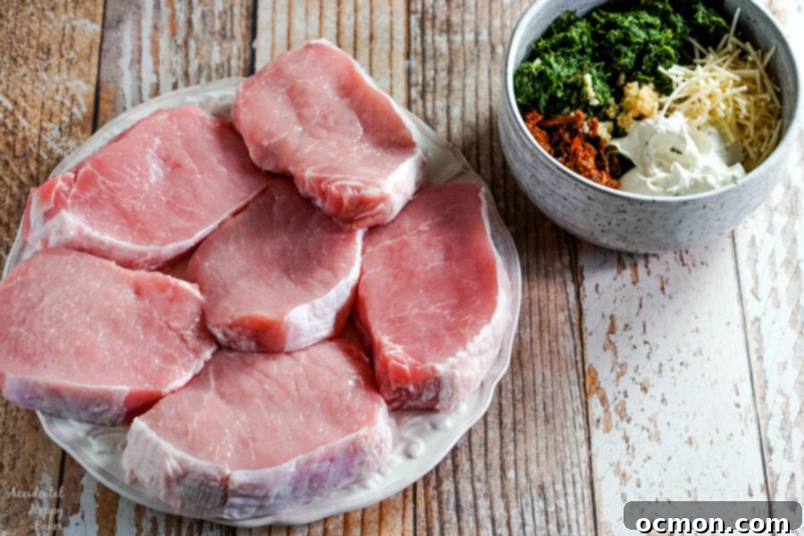 Savory Spinach-Filled Pork Chops 4 Ingredients for spinach stuffed pork chops laid out on a cutting board, ready for prep