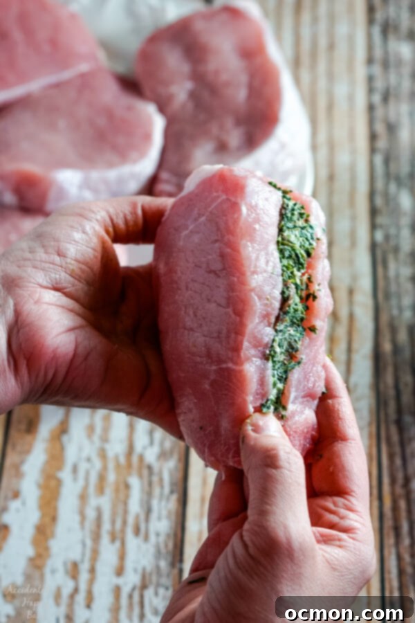 Savory Spinach-Filled Pork Chops 6 Mixing bowl with vibrant spinach, cream cheese, sun-dried tomatoes, and garlic combined for the filling