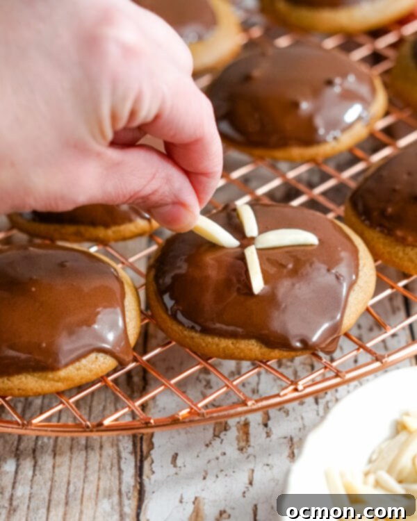 Delicate slivers of almond are carefully placed on the chocolate-dipped tops of the German Gingerbread Cookies to complete their festive decoration.