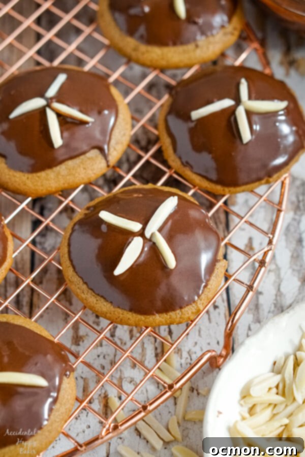 Freshly dipped and decorated German Gingerbread Cookies on a wire rack.