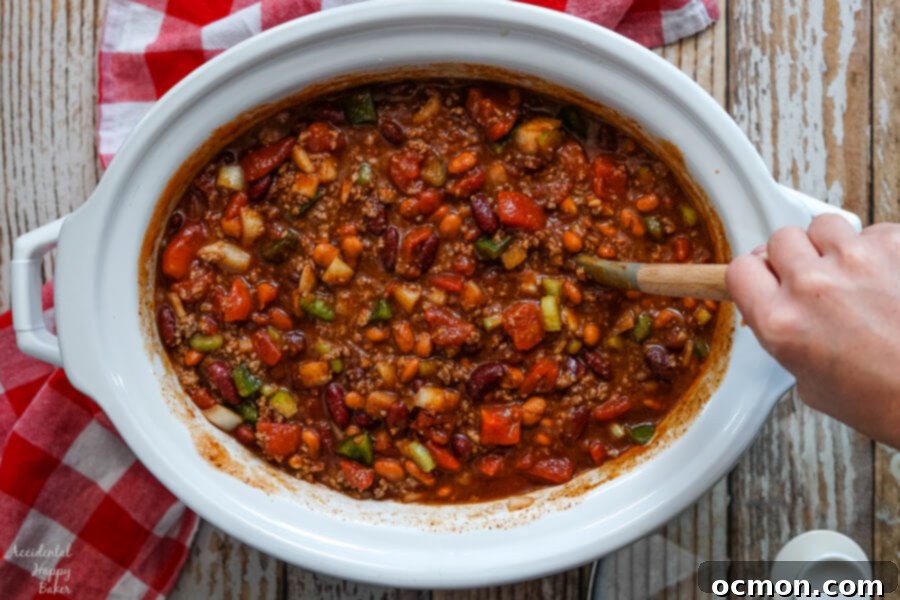 Stirring everything together before covering the slow cooker. 