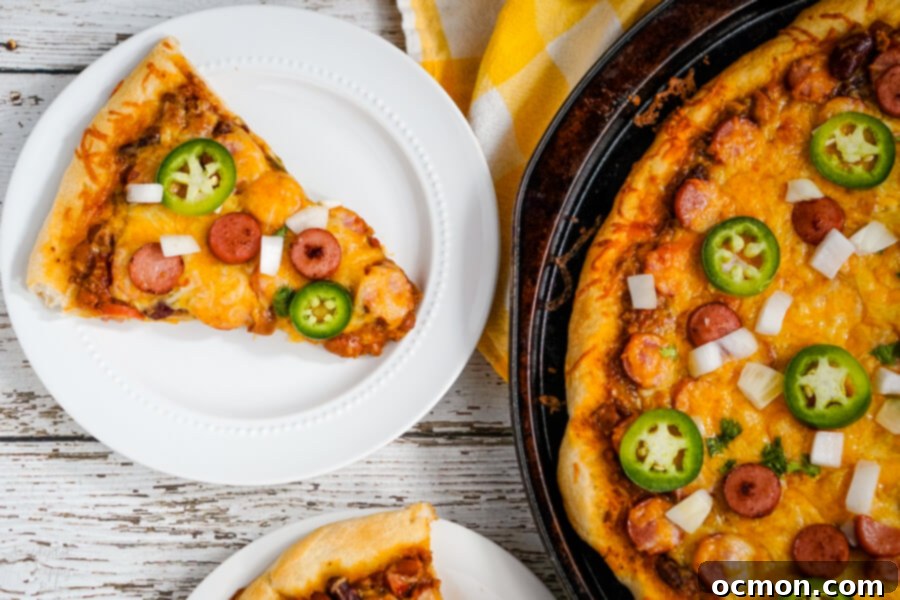 A slice of Chili Dog Pizza made with leftover chilii