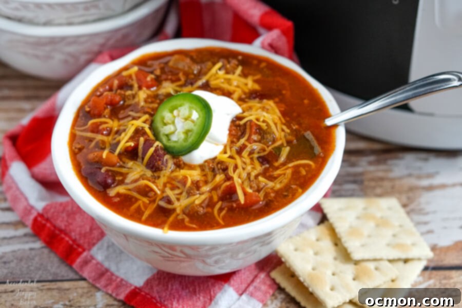 A white bowl full of Wendy's Copycat Chili on a red checked towel.