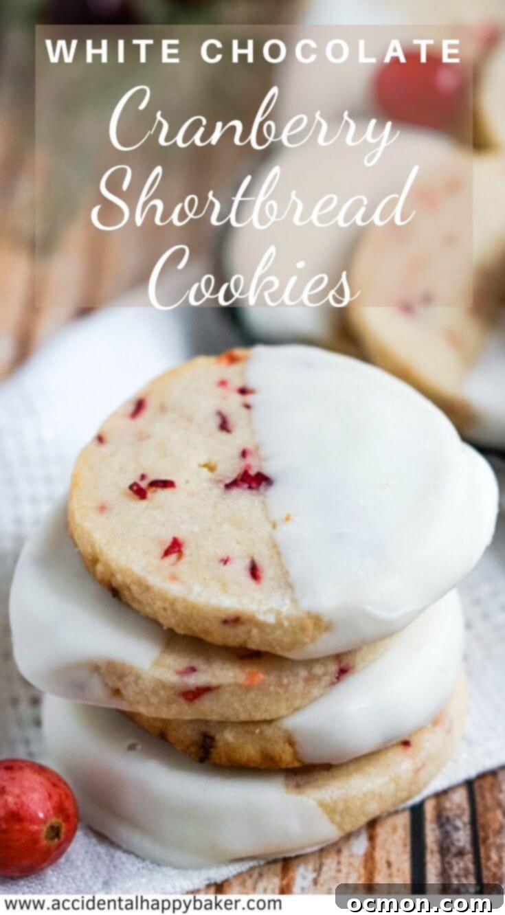 White Chocolate Cranberry Shortbread Cookies have fresh chopped cranberries, a buttery crisp texture, and are dipped in white chocolate. #christmascookies #cranberrycookies #shortbreadcookies