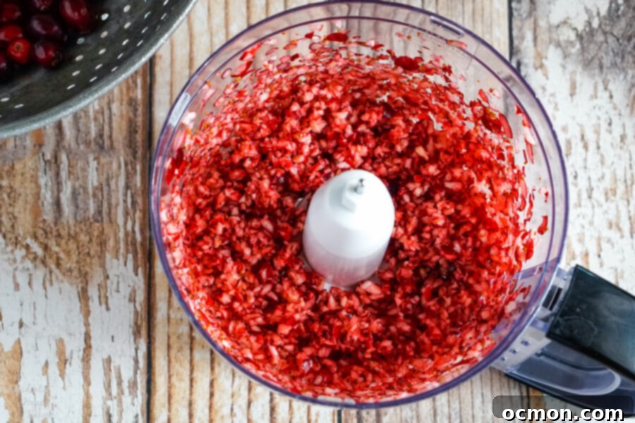 Finely chopped cranberries in the food processor bowl. 