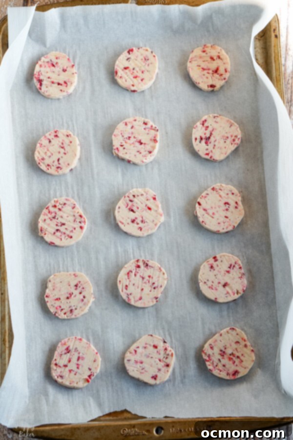 A sheet pan of sliced cookies ready to bake. 