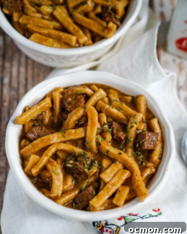 A close up image that shows the texture of the beef and noodles, highlighting the tender beef chunks and creamy noodles. 