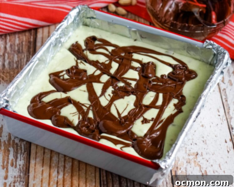 Melted dark chocolate is spooned over the hot fudge.