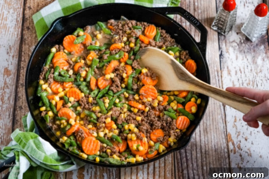 Crispy Tater Tot Shepherds Pie 5 Frozen mixed vegetables are added to the ground beef and gravy sauce in a cast iron skillet for Shepherd's Pie with Tater Tots.