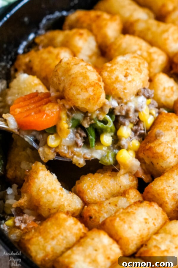 Crispy Tater Tot Shepherds Pie 7 A spoonful of Shepherd's Pie with Tater Tots is scooped out of the skillet.