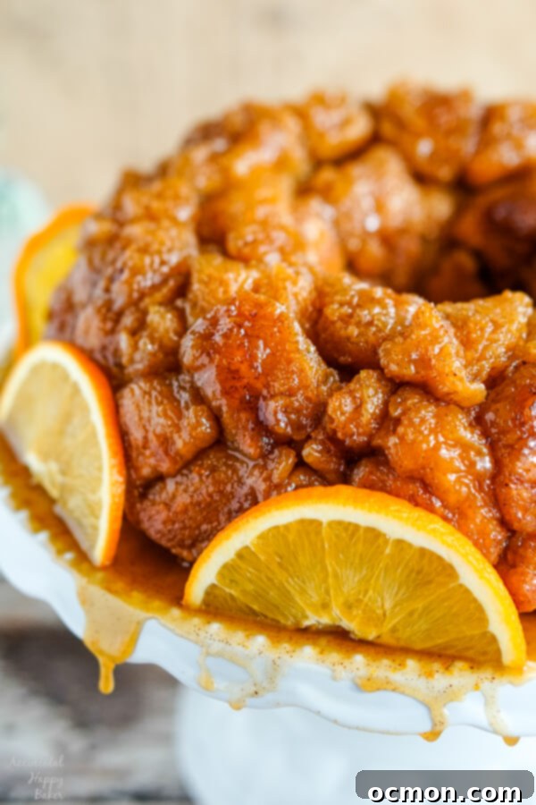 Citrus Spice Pull-Apart Bread 8 A platter of Orange Spiced Monkey Bread with syrup dripping off the platter.