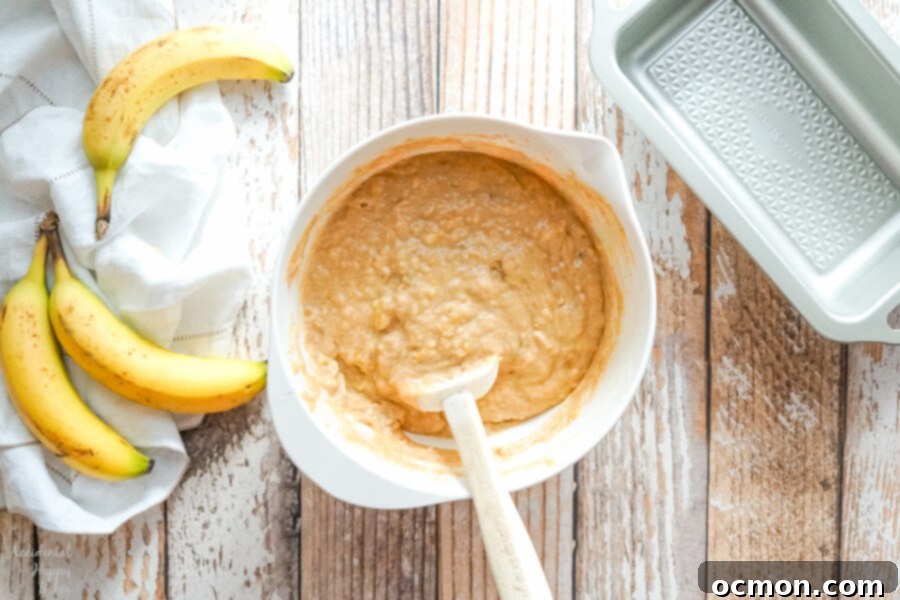A bowl of banana bread batter before stirring in the chocolate chunks. 