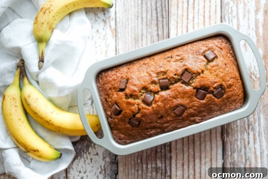 The loaf pan full of banana bread fresh from the oven. 