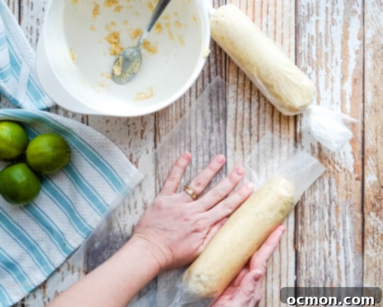 After the key lime pie shortbread cookie dough is made, it is shaped into logs and wrapped. 
