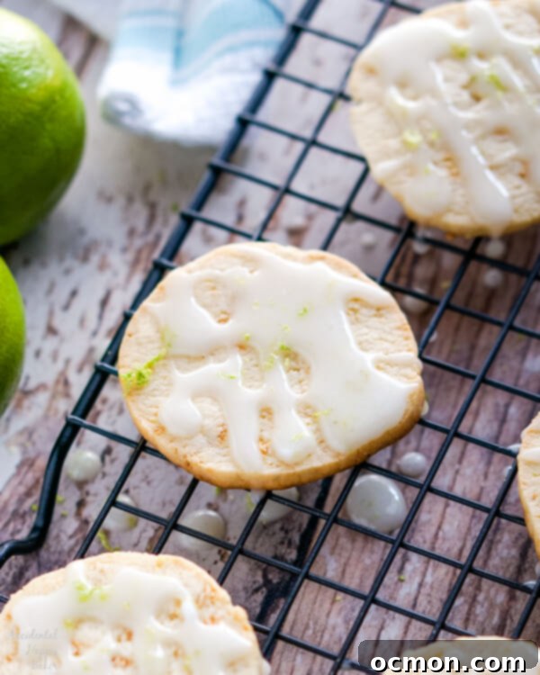 A wire rack full of glazed Key Lime Pie Shortbread Cookies