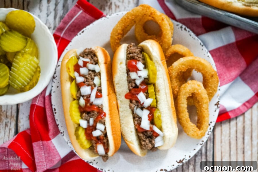 Two Loose Meat Sandwiches presented on a white plate, highlighting their distinctive texture and generous toppings.